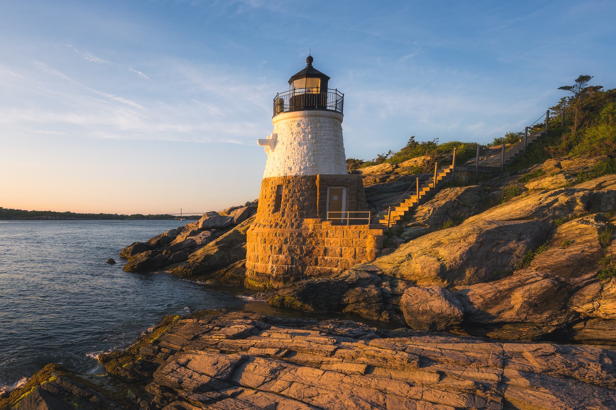 Castle Hill Lighthouse on the Newport, Rhode Island shoreline at golden hour